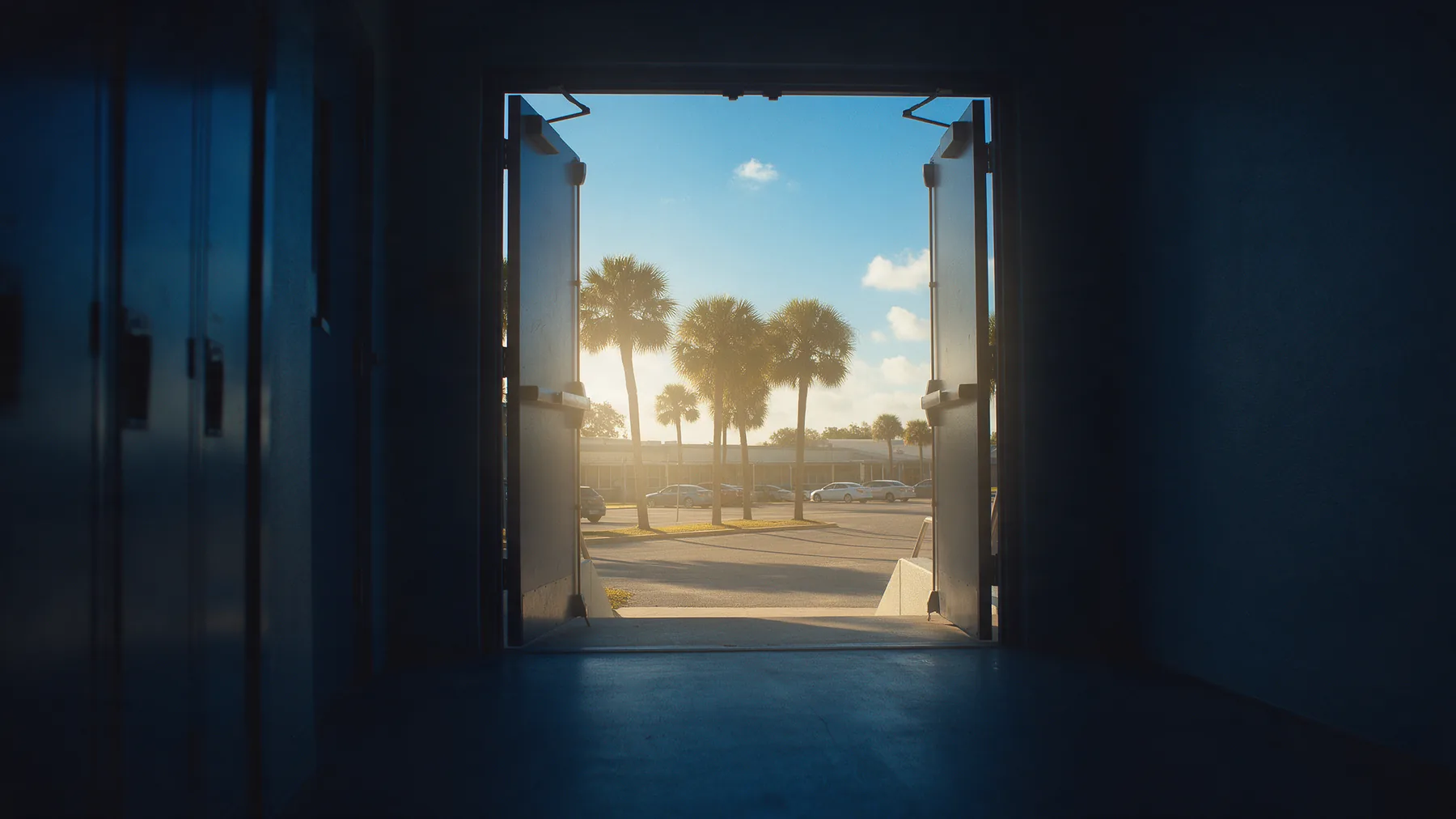 A school corridor opening onto bright Florida morning